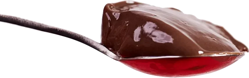 Close-up of a spoonful of Primo Chocolate High Protein Pudding with a smooth, glossy texture on a transparent background.